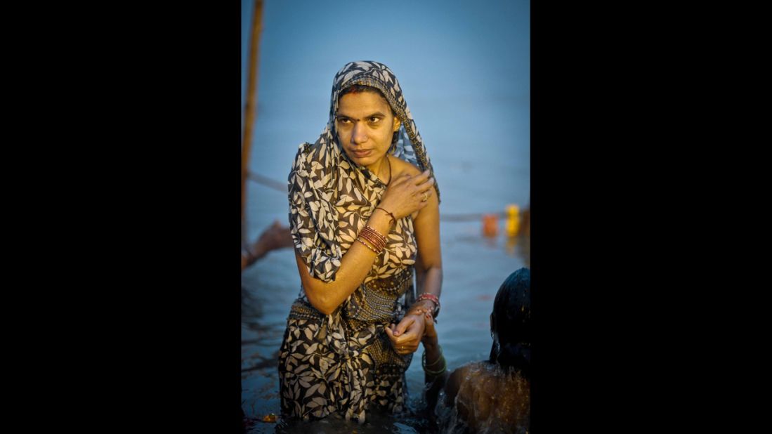 A woman rises out of the Sangam on February 17.