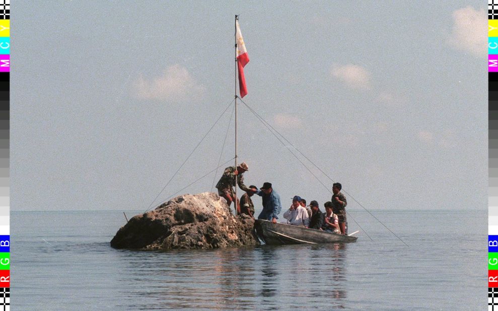 And this is what it's all about: A team of lawmakers plant a Philippines flag on a tiny rock at the Scarborough Shoal on May 17 last year.