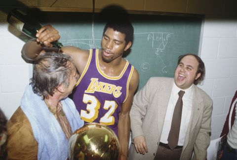 The Lakers won their first of 10 championships under Buss. Veteran center Kareem Abdul-Jabbar averaged a monstrous 32 points, 13 rebounds and four blocks during the playoffs, but he had to share the stage with a 20-year-old rookie who would soon become a legend himself, Earvin "Magic" Johnson. Pictured, Johnson dumps champagne on Buss after winning a game in the 1980 series. 