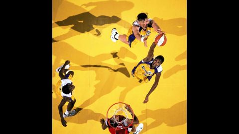 After the WNBA is formed, Buss operated the Los Angeles Sparks franchise. Lisa Leslie joined the inaugural team in 1997, proving Buss' reputation for snaring supreme talent knew no gender boundary. Leslie's storied career included seven All-Star appearances, four Olympic gold medals and two WNBA titles. Pictured, Leslie grabs a rebound during a 1997 WNBA game against the Houston Comets.