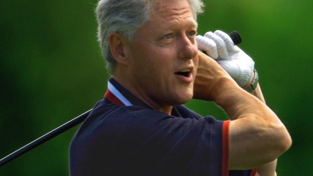President Bill Clinton watches as his first tee shot heads off the course and into the trees at the Farm Neck Golf Club of Martha's Vineyard during a family vacation on August 23, 1999. Known for taking mulligans, or friendly do-over shots, his second attempt landed in the same spot.