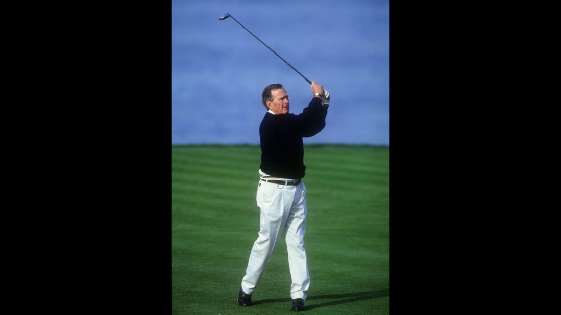 President George H. W. Bush tees off on the fourth hole at Spyglass Golf Course during the AT&T Pebble Beach National Pro-Am on February 28, 1994, in Pebble Beach, California.