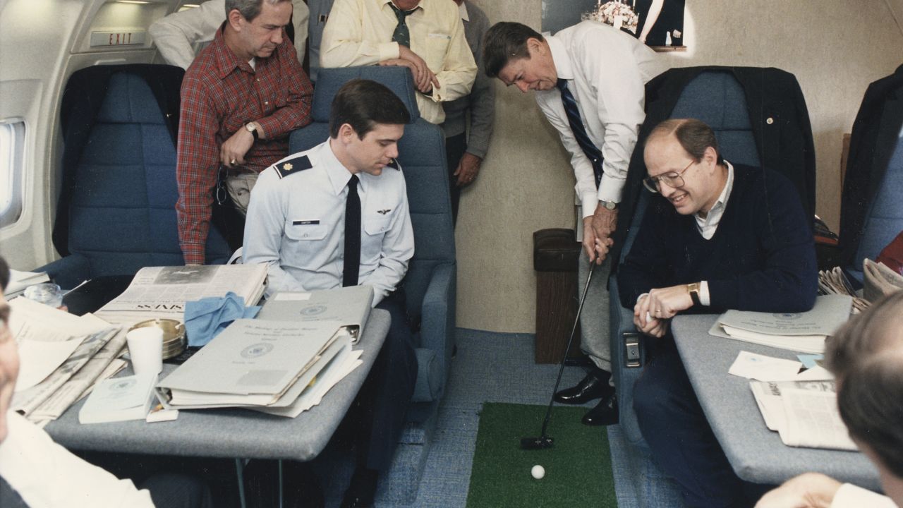 President Ronald Reagan putts a golf ball on Air Force One on November 16, 1985.