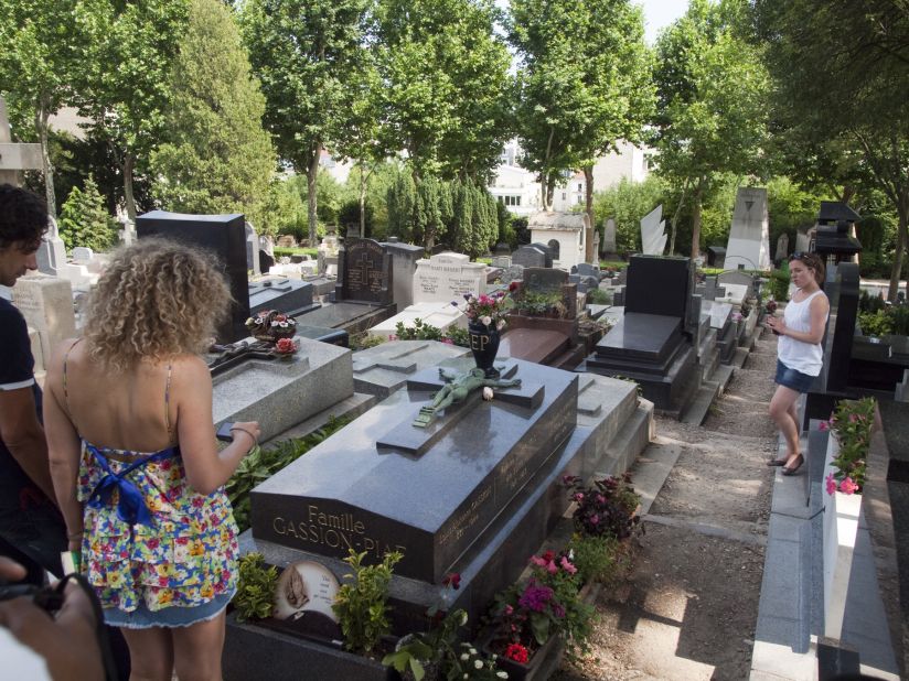 And still they come. Visitors pay respects at the grave of legendary French singer Édith Piaf at Père Lachaise Cemetery in Paris.