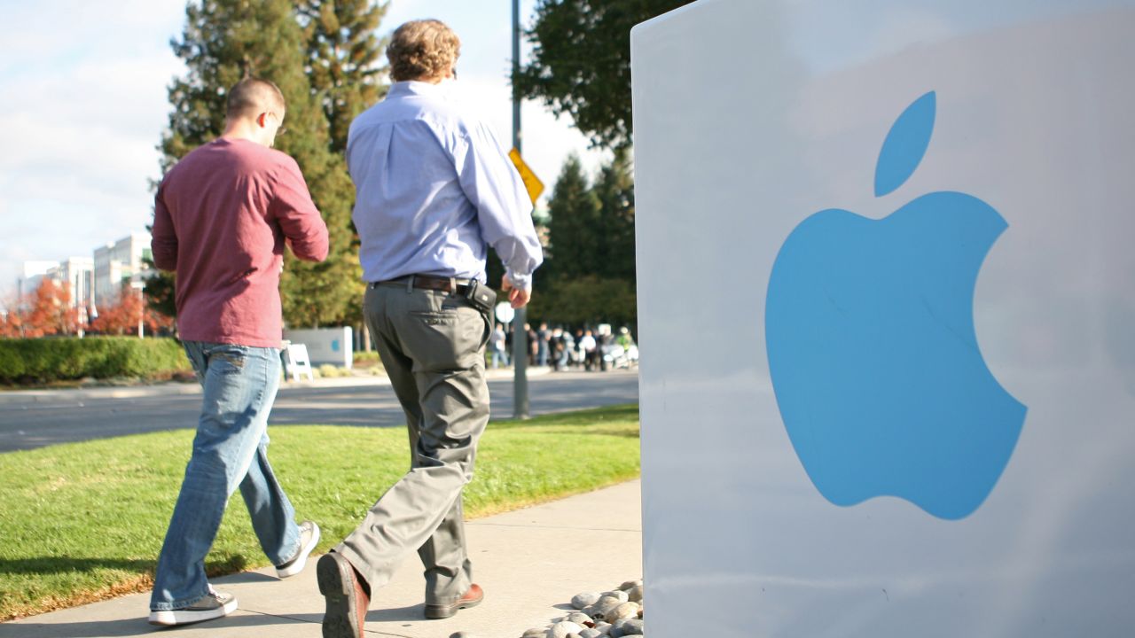Employees stroll on Apple's campus in Cupertino, California. The company says a small number of its computers were hacked.