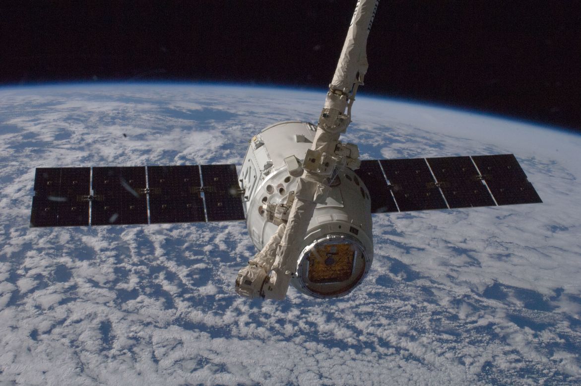 The unmanned SpaceX Dragon spacecraft connects to the space station in May 2012. It was the first private spacecraft to successfully reach an orbiting space station.
