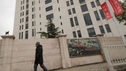 A person walks past a 12-storey building alleged in a report on February 19, 2013 by the Internet security firm Mandiant as the home of a Chinese military-led hacking group after the firm reportedly traced a host of cyberattacks to the building in Shanghai's northern suburb of Gaoqiao. Mandiant said its hundreds of investigations showed that groups hacking into US newspapers, government agencies, and companies 'are based primarily in China and that the Chinese government is aware of them.'  