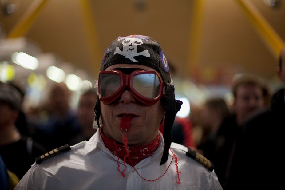  A Spanish Airline Iberia staff member blows a whistle during a protest against job cuts at Barajas Airport.