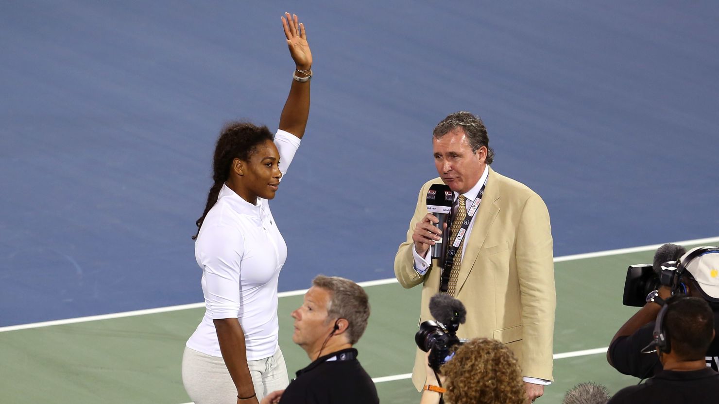 Serena Williams delivers an on court interview as she withdraws from her match on the third day of the Dubai event. 