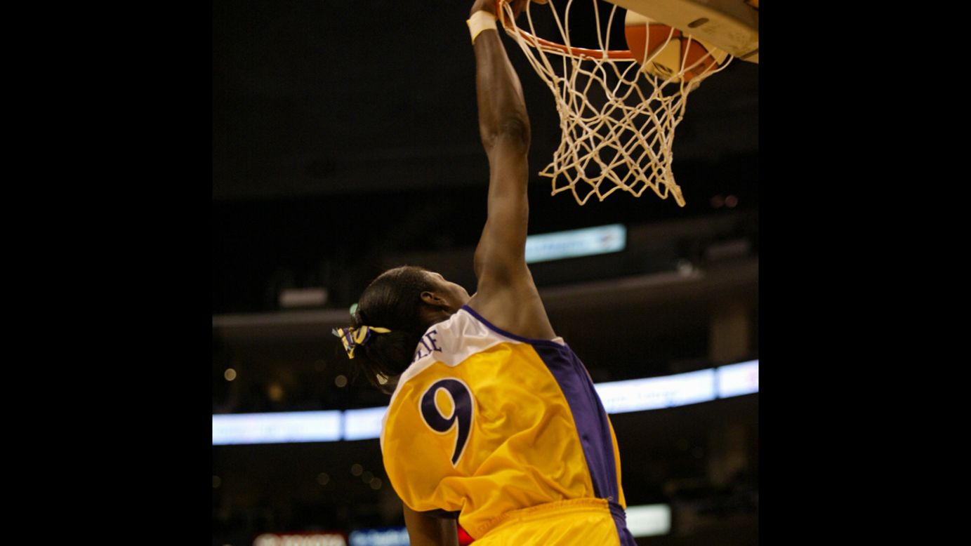 Lisa Leslie of the Los Angeles Sparks records the first slam dunk in women's professional basketball during a game against the Miami Sol on July 30, 2002, in Los Angeles.