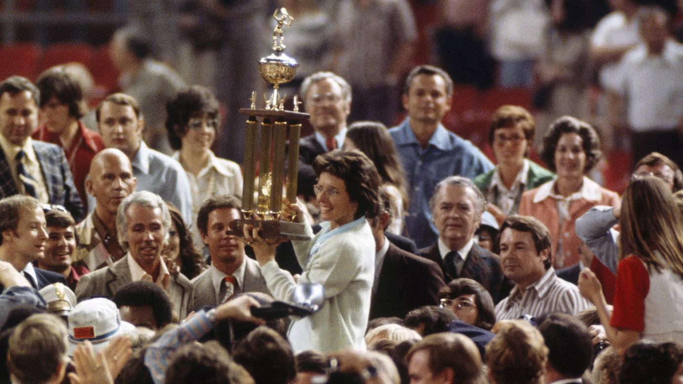 Billie Jean King holds up her trophy after defeating Bobby Riggs during the Battle of the Sexes tennis match in Houston on September 20, 1973. She became the first woman to beat a man in a professional tennis match.