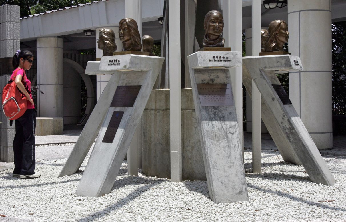 A woman looks at the SARS memorial site in Hong Kong Park, which features a monument to the seven health workers who died during their efforts to control the SARS outbreak.