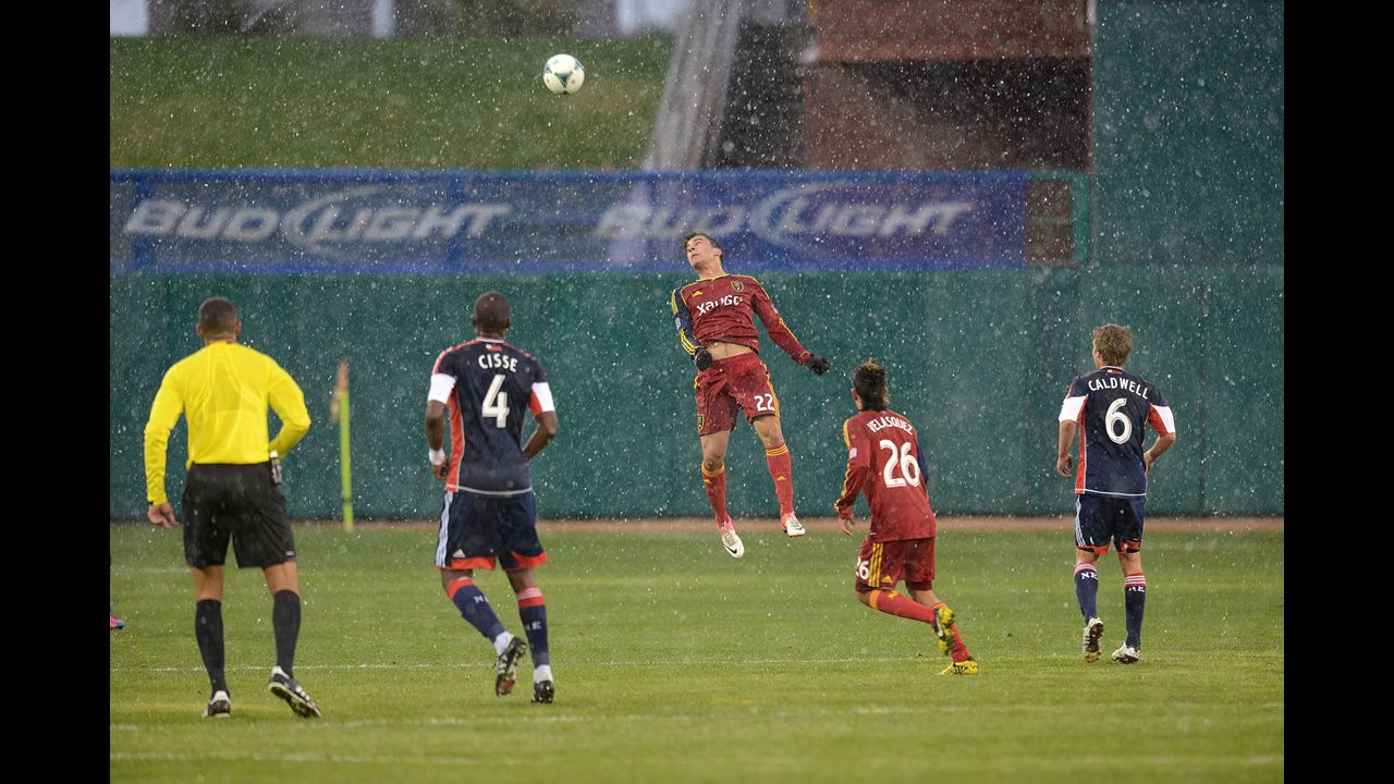 David Viana of the Real Salt Lake soccer team heads the ball against the New England Revolution during the snowfall on Wednesday in Tucson, Arizona.