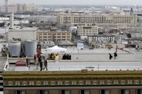 Authorities stand on the rooftop of the hotel as the recovery continues. 