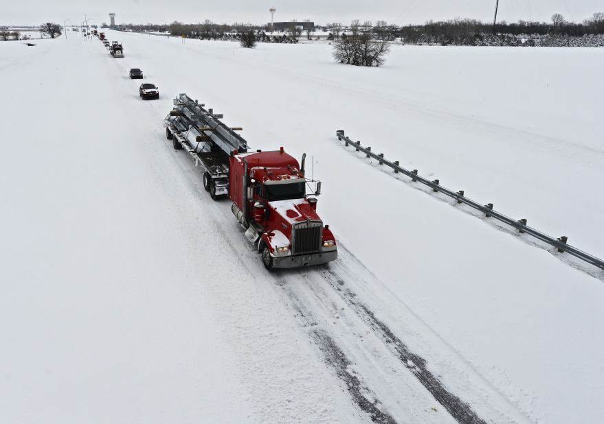 Vehicles drive in single file down Highway 135 outside Wichita on Thursday.