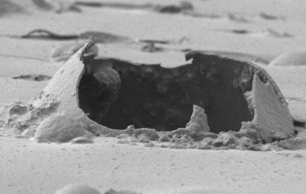 This image, taken using a scanning electron microscope, shows a ruptured microcapsule contained in a self-healing epoxy.