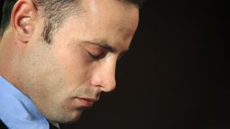 South African Olympic sprinter Oscar Pistorius is pictured at the Magistrate Court in Pretoria on February 22, 2013. Pistorius battled to secure bail as he appeared on charges of murdering his model girlfriend Reeva Steenkamp on February 14, Valentine's Day. South African prosecutors will argue that Pistorius is guilty of premeditated murder in Steenkamp's death, a charge which could carry a life sentence. Pistorius denies the charge, saying that he shot 29-year-old Steenkamp repeatedly through a locked bathroom door in the dead of night by accident, having mistaken her for a burglar. AFP PHOTO / ALEXANDER JOE        (Photo credit should read ALEXANDER JOE/AFP/Getty Images)