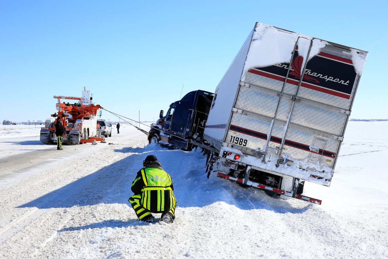 Tow truck drivers aid a semi on February 22 in Greensburg, Kansas.
