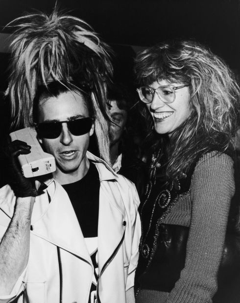 Tony James, bassist for British New Wave band Sigue Sigue Sputnik, with his girlfriend Janet Street Porter, in 1986. This brick-like model is also known as a <a href="http://www.urbandictionary.com/define.php?term=Zack%20Morris%20phone" target="_blank" target="_blank">"Zack Morris phone"</a> after the phone-toting character on TV's "Saved by the Bell."