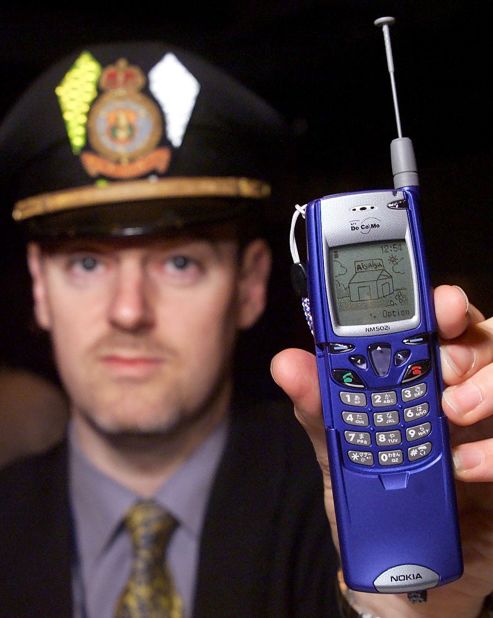 Nigel Rundstrom of Nokia shows off the company's new mobile phone, the catchily named DoCoMo Nokia NM502i, in Tokyo in March of 2000. No explanation was given for his hat.