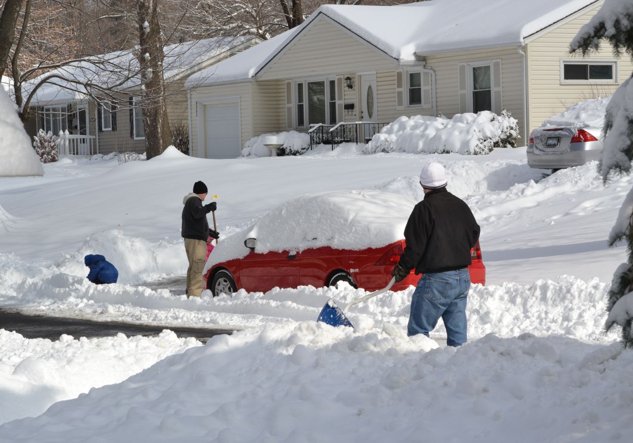 Twelve to 14 inches of snow fell in northeastern Kansas on Thursday, February 21. However, on Friday, February 22, the sun was out, and this street had been cleared, but many were not. Neighbors worked to clear their driveways while the kids enjoyed playing the deepest snow many of them had ever experienced. 