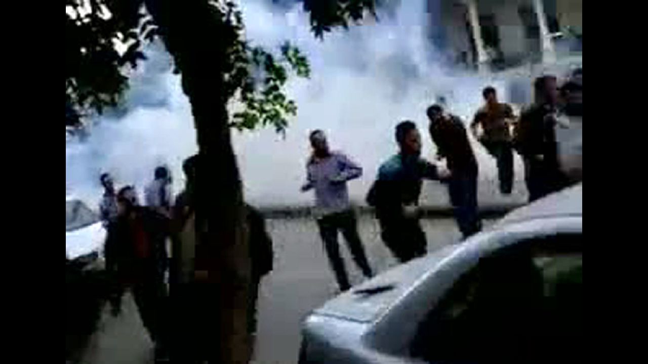 A screen grab from YouTube shows Syrian anti-government protesters run for cover from tear gas fired by security forces in Damascus on April 29, 2011, during the "Day of Rage" demonstrations called by activists to put pressure on al-Assad.