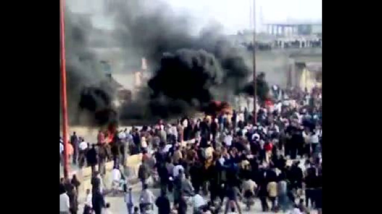 A screen grab from YouTube shows thick smoke rising above as Syrian anti-government protesters demonstrate in Moaret Al-Noman on April 29, 2011.