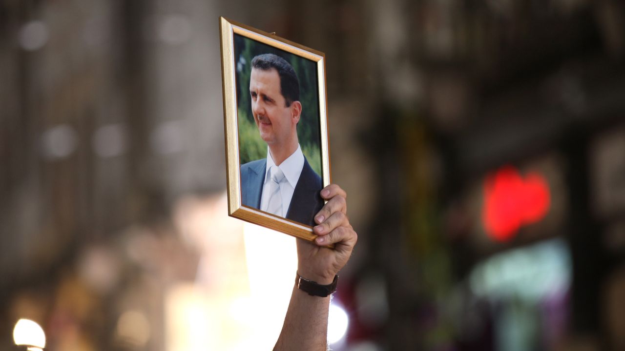 A Syrian man holds up a portrait of President Bashar al-Assad during a rally to show support for the president in Damascus on April 30, 2011.