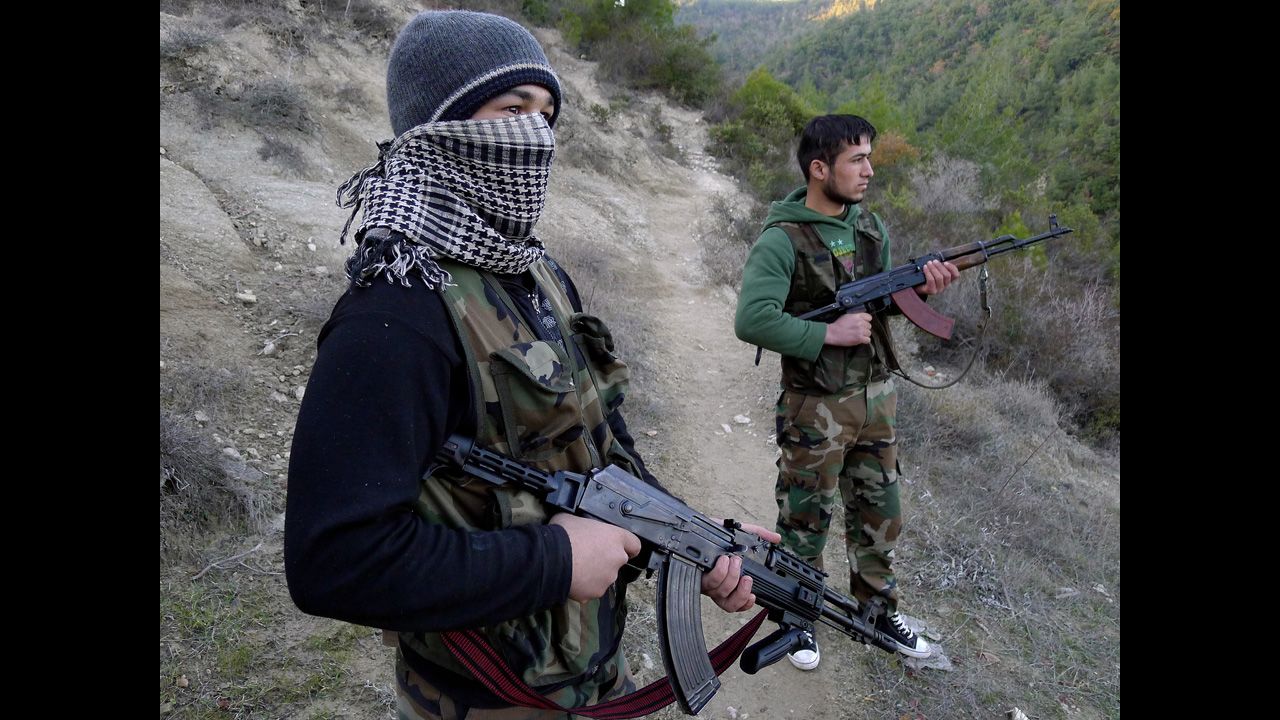 Members of the Free Syrian Army stand in an valley near the village of Ain al-Baida, close to the Turkish border, on December 15, 2011.
