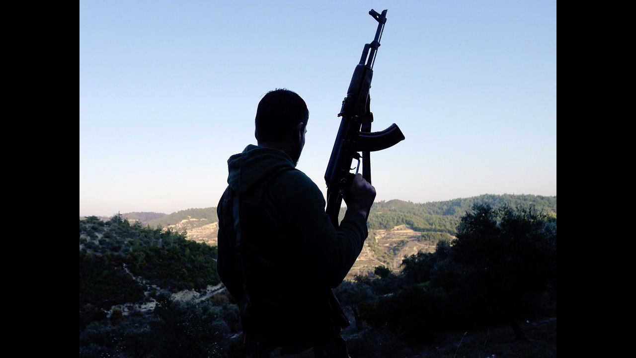 A member of the Free Syrian Army looks out over a valley in the village of Ain al-Baida on December 15, 2011.