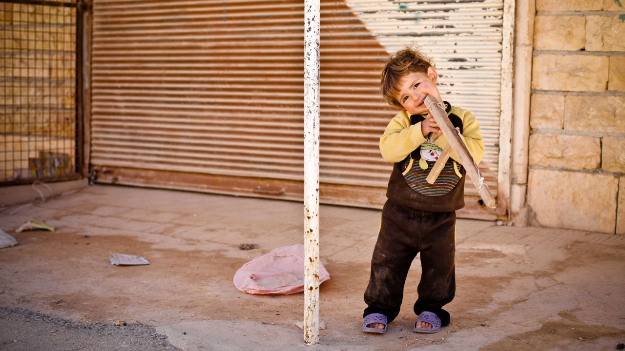 A young boy plays with a toy gun in Binnish on April 9.