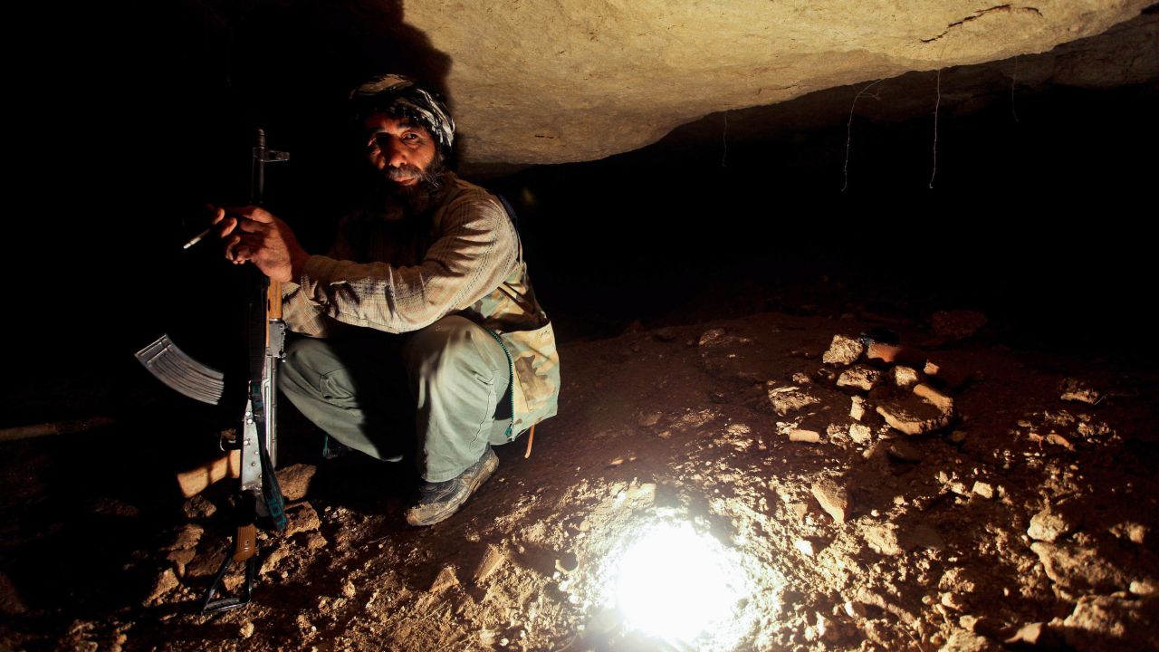 A Free Syrian Army member takes cover in underground caves in Sarmin on April 9, 2012.