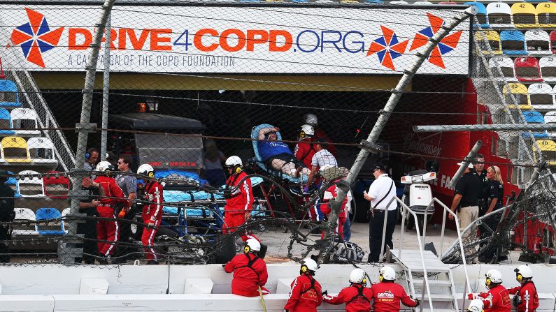 Medical personnel remove an injured fan from the stands.