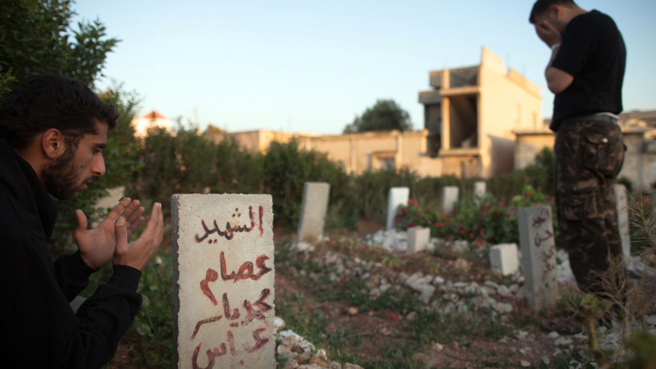 Members of the Free Syrian Army's Mugaweer (commandos) Brigade pay their respects in a cemetery on May 12 in Qusayr.