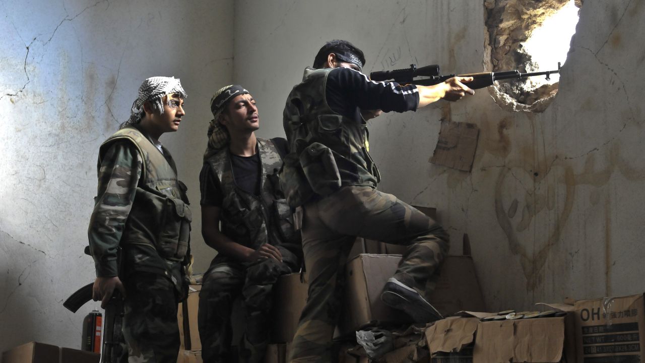 Rebels hold their position in the midst of a battle on November 3 in Aleppo.