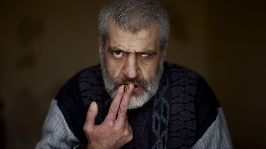 A patient smokes a cigarette at Dar Al-Ajaza psychiatric hospital in Aleppo on December 18, 2012. The psychiatric ward, housing around 60 patients, has lacked the means to function properly since fighting broke out there in July.