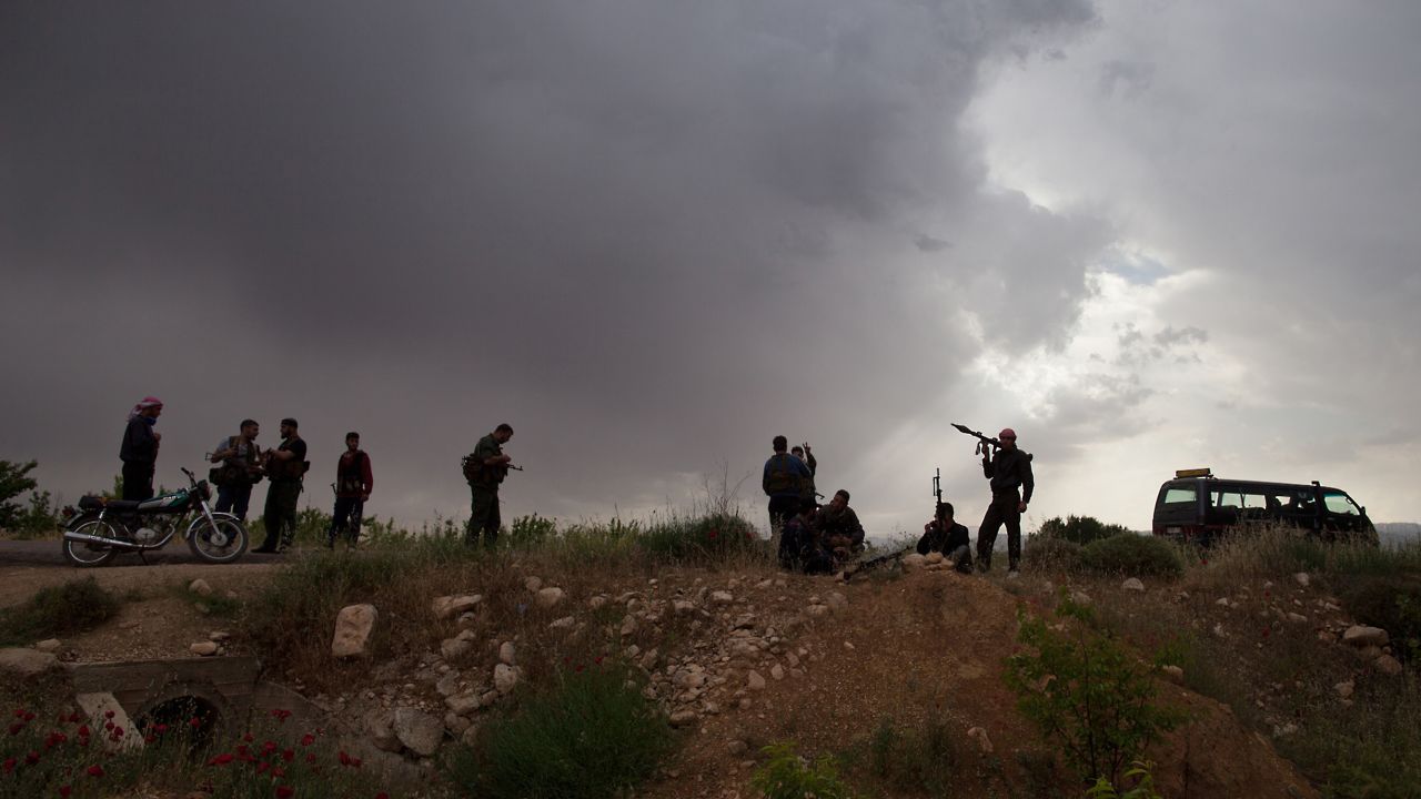 Syrian rebels take position near Qusayr on May 10.