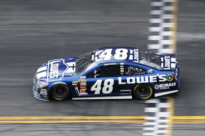 Jimmie Johnson crosses the finish line to win the Daytona 500. Dale Earnhardt Jr. finished second, and Mark Martin finished third.