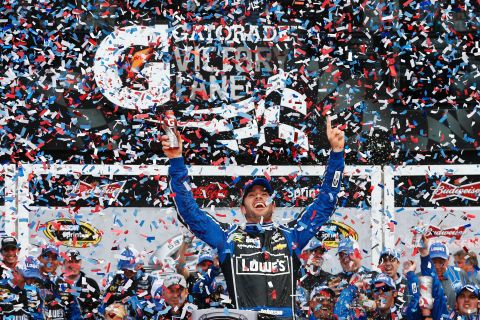 Jimmie Johnson raises his arms in victory after winning the NASCAR Sprint Cup Series Daytona 500 on Sunday, February 24, in Daytona Beach, Florida.