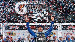Jimmie Johnson raises his arms in victory after winning the NASCAR Sprint Cup Series Daytona 500 on Sunday, February 24, in Daytona Beach, Florida.