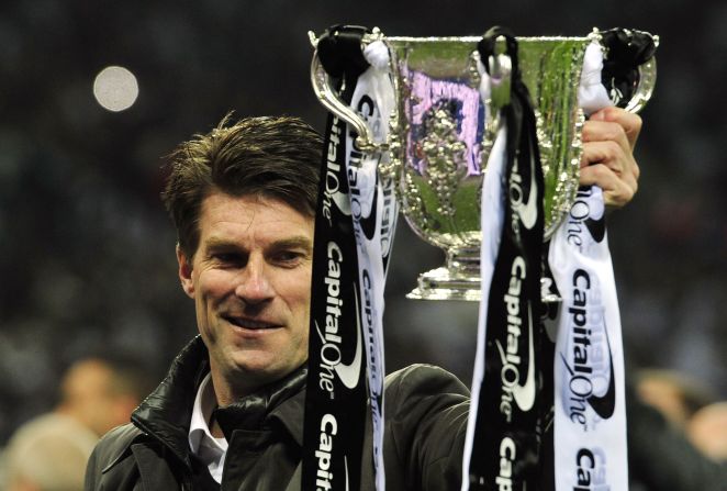 Swansea manager Michael Laudrup gets his hands on the English League Cup after his side's 5-0 final win over Bradford at Wembley. 