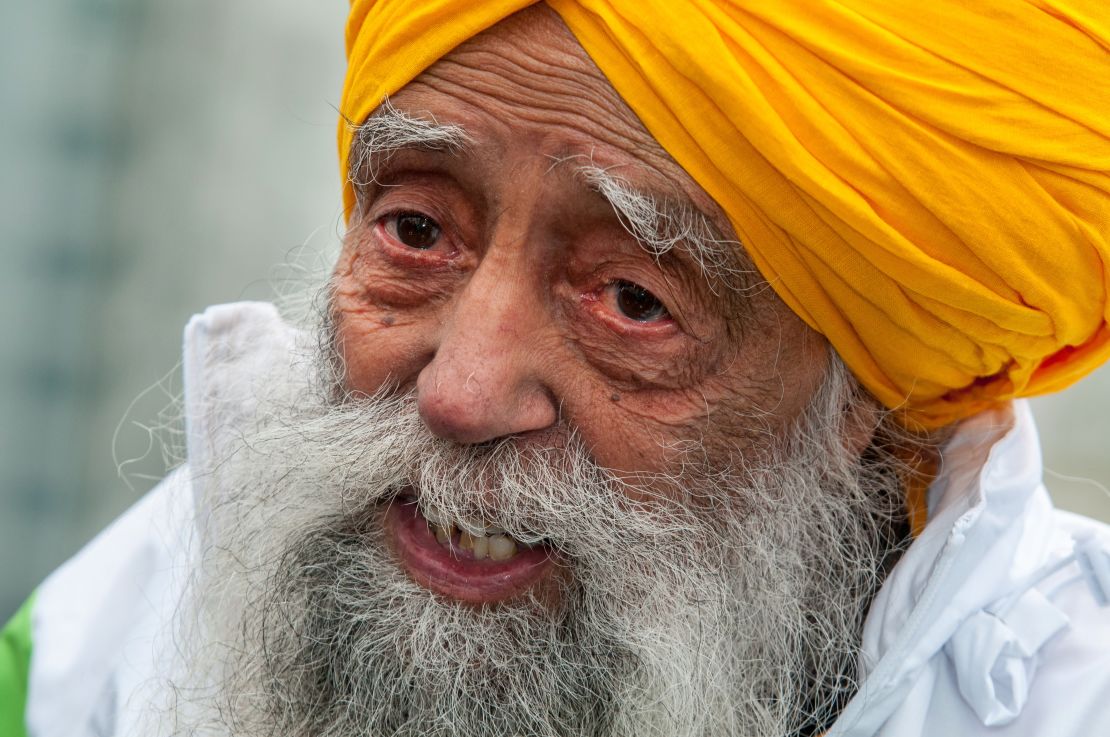 Fauja Singh smiles after completing the 10-kilometer run during the 2013 Hong Kong Marathon on Sunday.