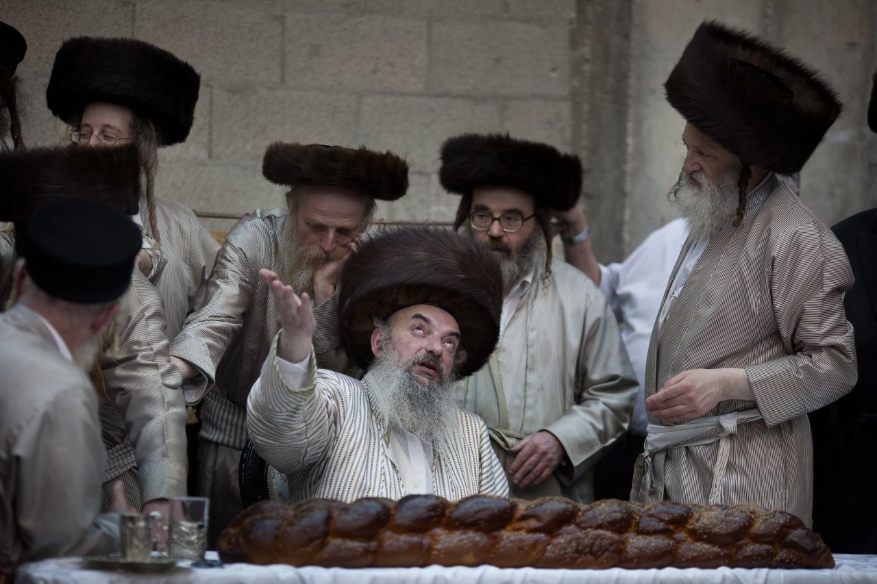 Ultra-Orthodox Jews from the Lelov Hasidic sect gather around their rabbi as they celebrate the Jewish festival of Purim in Beit Shemesh, Israel. 