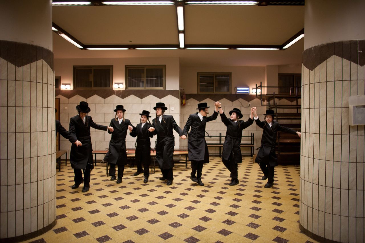 Ultra-Orthodox Jews celebrate Purim at a synagogue. Dancing is a vital part of the celebrations...