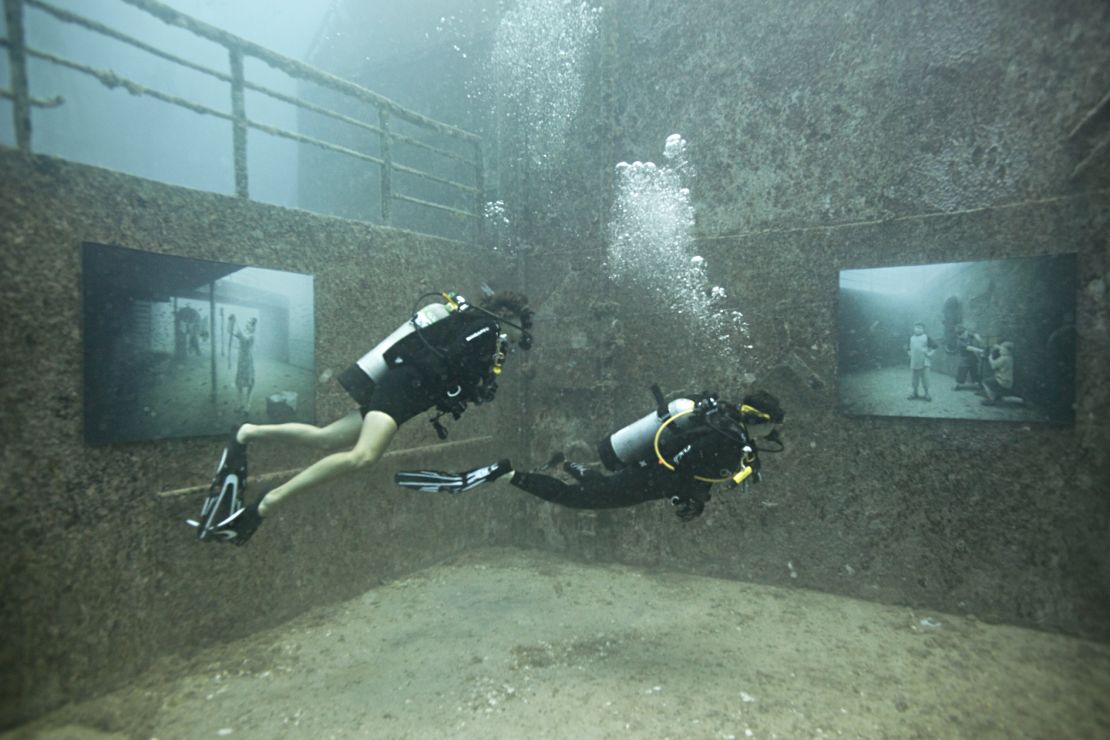 Divers check out the the photo gallery on sunken ship USNS General Hoyt S.Vandenberg, off the coast of Florida.