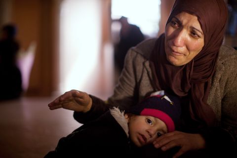 The sister of of Arafat Jaradat mourns, while holding his son Muhannad, during his funeral on February 25, 2013 in the village of Saair in the West Bank.
