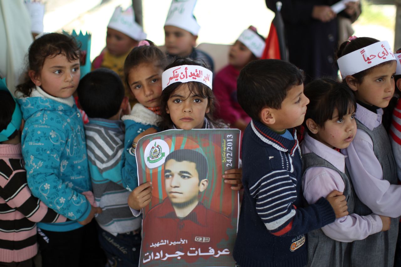 A Palestinian girl carries a poster of Arafat Jaradat at Erez border crossing between Israel and the northern Gaza Strip. 