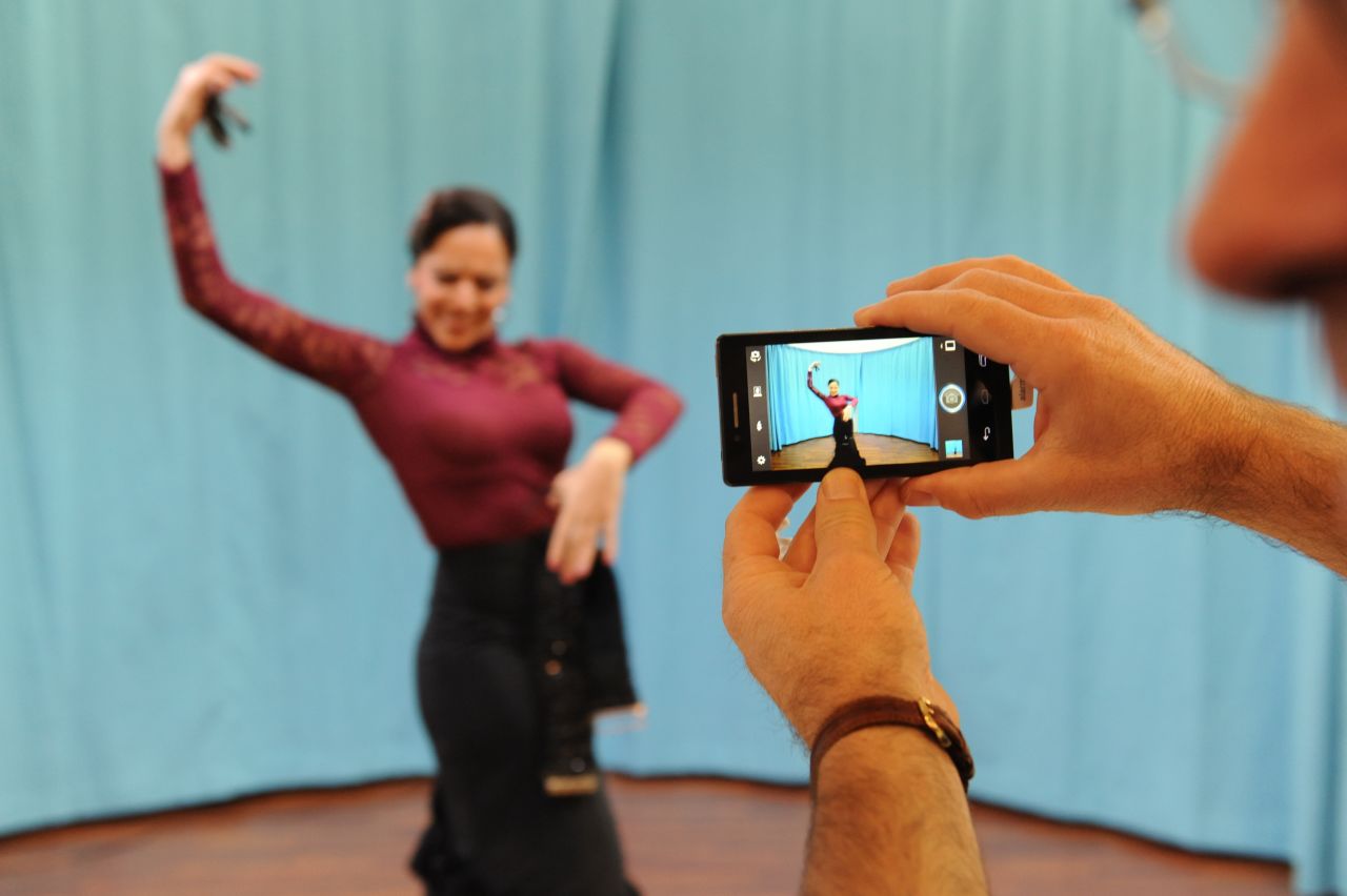 A flamenco dancer performs for visitors at the Mobile World Congress to demonstrate the imaging capabilities of Intel's latest smartphone design.