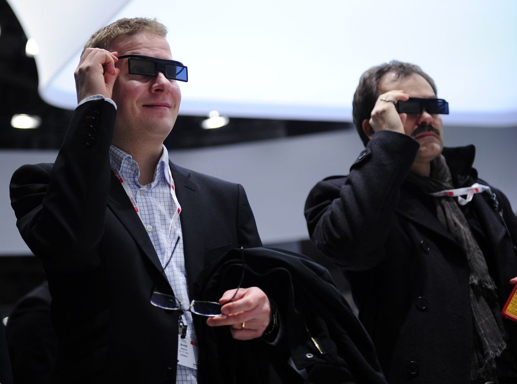 Two men test a new Samsung 3D device during the first day of the Mobile World Congress.