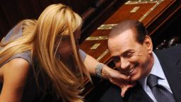 Member of parliament Michaela Biancofiore squeezes Italian Prime Minister Silvio Berlusconi's chin at the Parliament in Rome on August 3, 2011. 